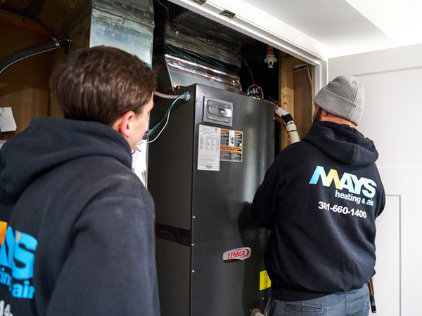 Men looking at a new furnace installation