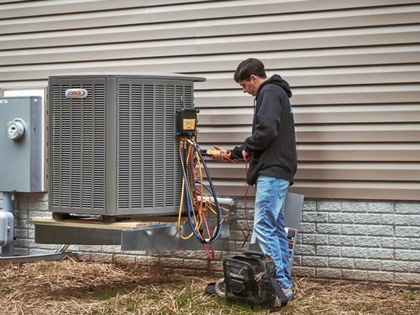 Mays performing maintenance on an air conditioner